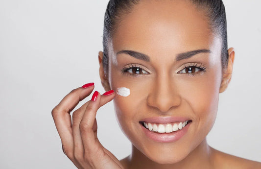 smily woman applying stellante lightening cream on face